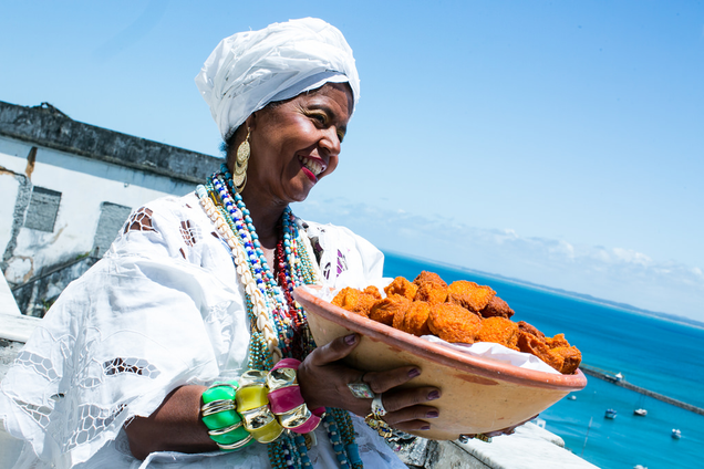 Baianas de Acarajae traditionally dressed in white to sell acarajae—an Afro-Brazilian snack food. (Ministry of Culture of Brazil)